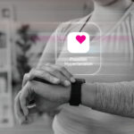 Woman checking her Apple Watch after receiving a possible hypertension notification.