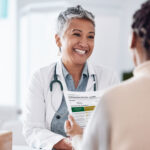 A doctor and patient reviewing health data together, showing how to talk to your doctor with more clarity and confidence.